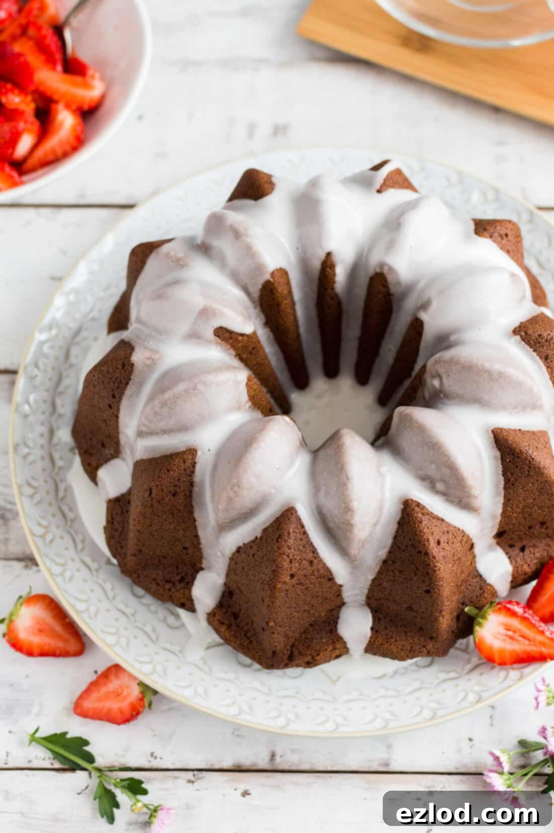 Vegan Ginger Bundt with Zesty Lime Drizzle and Sweet Strawberries 6 Side shot of vegan ginger bundt cake topped with a lime glaze and served with macerated strawberries.