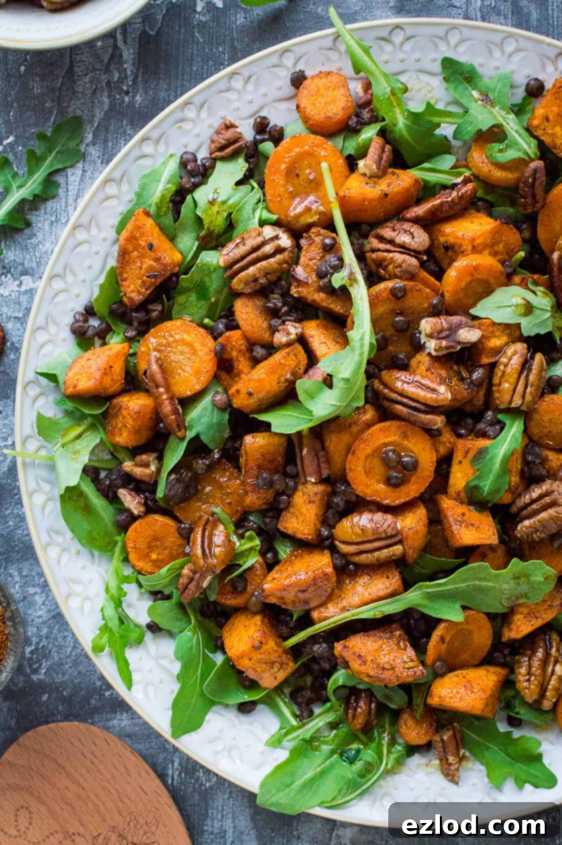 Wholesome Roasted Sweet Potato and Lentil Arugula Bowl 1 Roasted sweet potato, lentil and rocket salad – this hearty salad is filled with Ras el Hanout spiced roasted sweet potato and carrot, puy lentils, rocket  (arugula) and toasted pecans. #vegan #salad #healthy