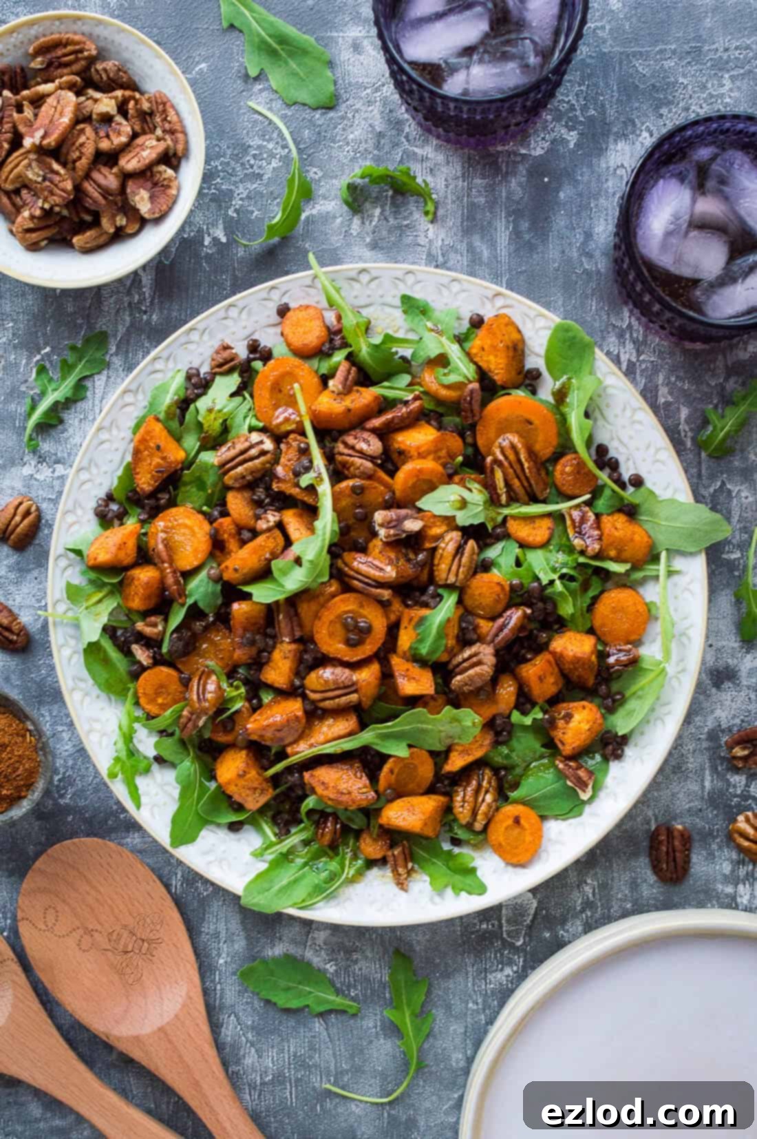 Wholesome Roasted Sweet Potato and Lentil Arugula Bowl 2 A plate of vegan roasted sweet potato, lentil and rocket salad with toasted pecans and pomegranate molasses dressing