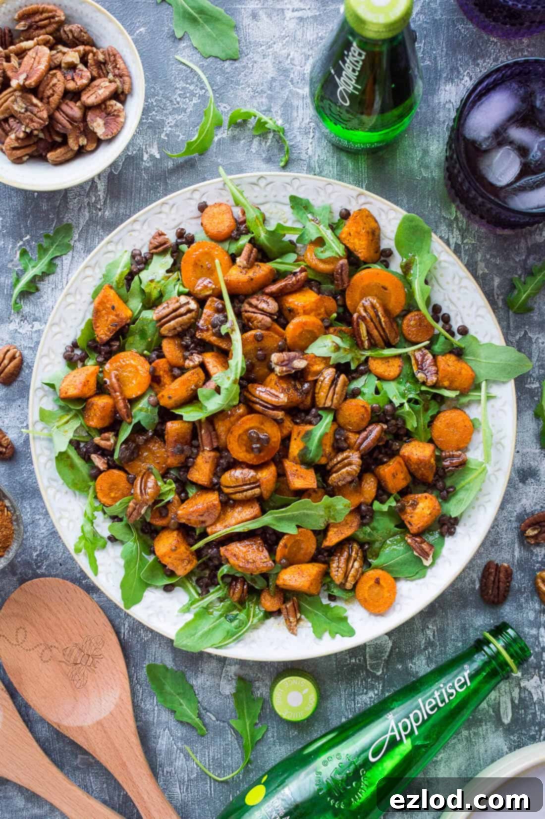 Wholesome Roasted Sweet Potato and Lentil Arugula Bowl 5 A white platter of roast sweet potato, puy lentil, rocket (arugula) and pecan salad with Appletiser