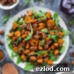 Wholesome Roasted Sweet Potato and Lentil Arugula Bowl 7 A plate of vegan roasted sweet potato, lentil and rocket salad with toasted pecans and pomegranate molasses dressing