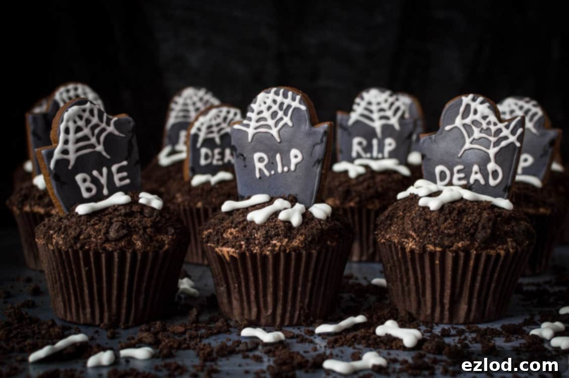 Plant-Based Graveyard Halloween Treats 4 Vegan graveyard cupcakes in a row on a dark background