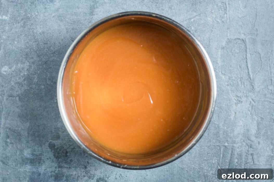 Luscious Vegan Blood Orange Curd 7 Step 3: Adding vegan butter to the hot blood orange curd mixture and stirring until melted and smooth.