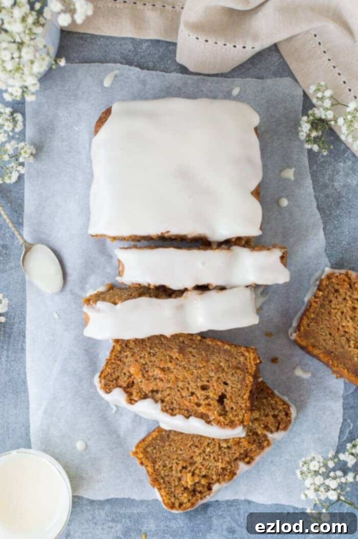 Spiced Vegan Carrot Bread 2 A perfectly baked vegan carrot cake loaf, moist and flavorful, topped with a luscious lemon glaze, ready for serving. Ideal for vegan baking enthusiasts.