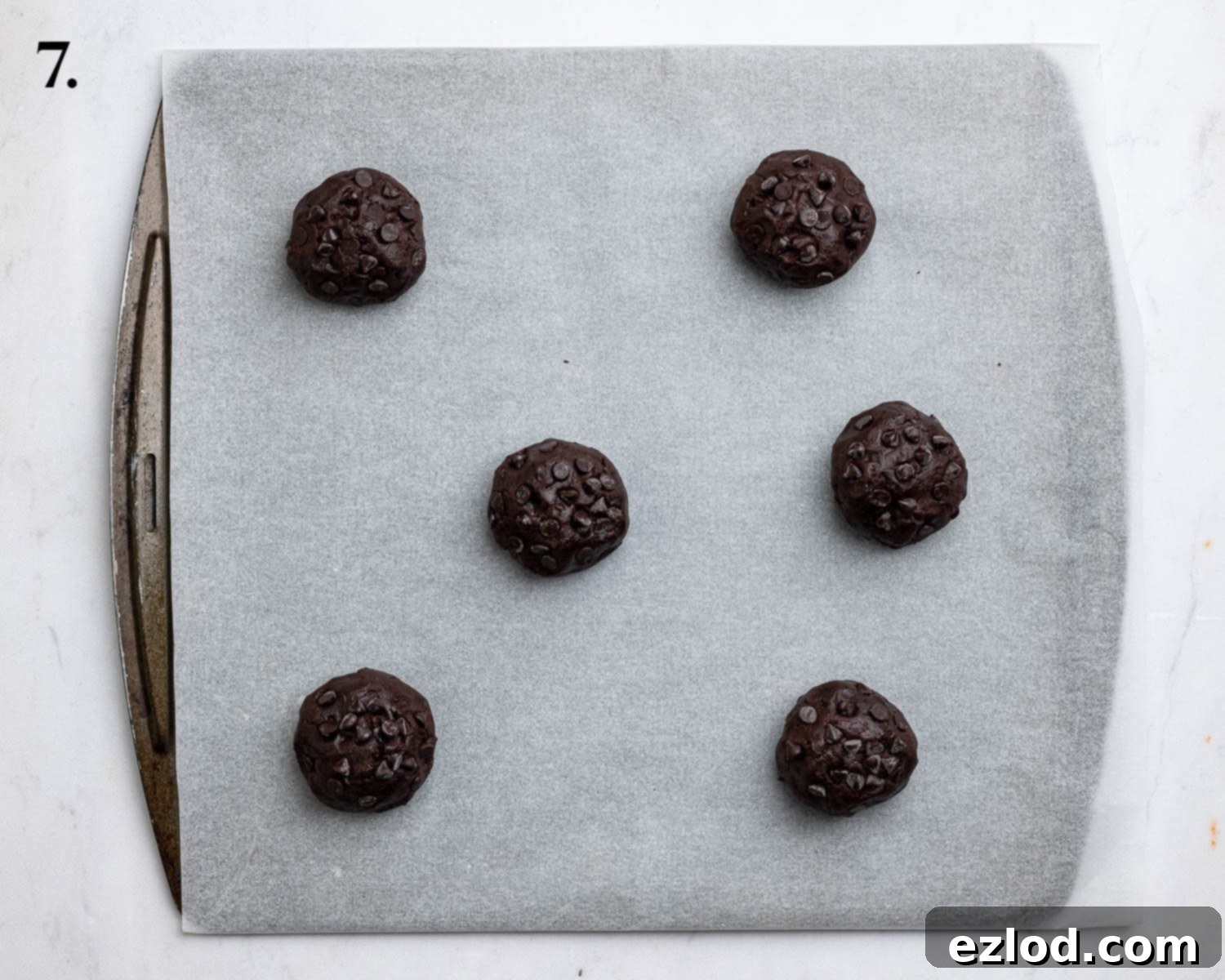 Step 7: Arranging stuffed cookie dough balls on baking sheets before baking.