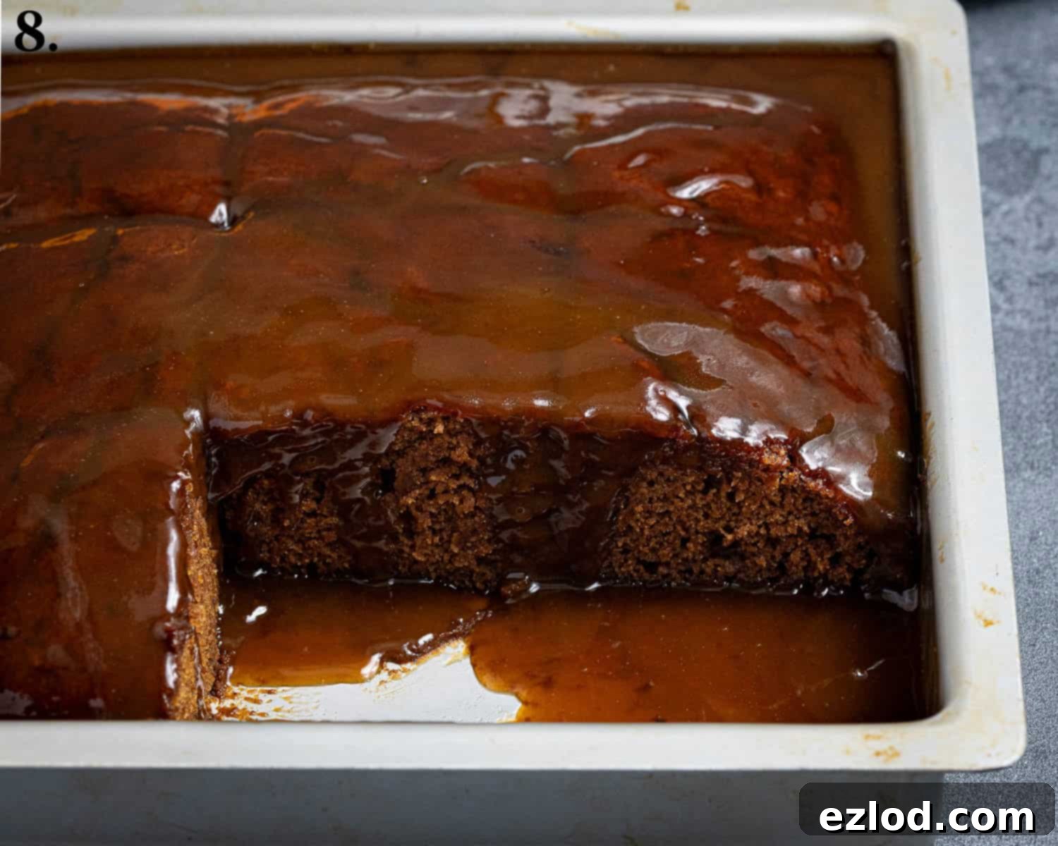 Spiced Pumpkin Sticky Toffee Pudding 12 Step 8: The sticky toffee pudding perfectly sliced into individual squares within the baking tin, ready for serving.
