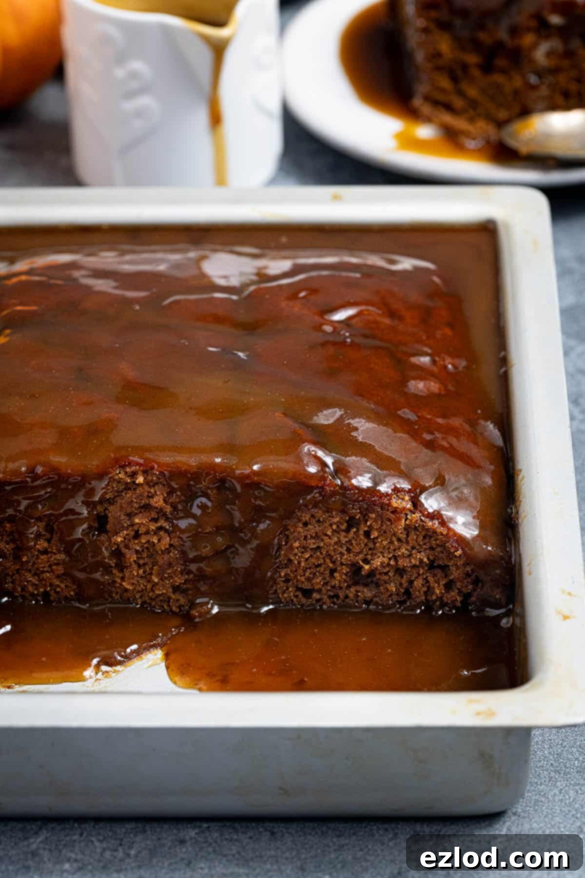 Spiced Pumpkin Sticky Toffee Pudding 13 A close-up view of a slice of vegan pumpkin sticky toffee pudding, highlighting its moist texture and rich, sticky glaze.