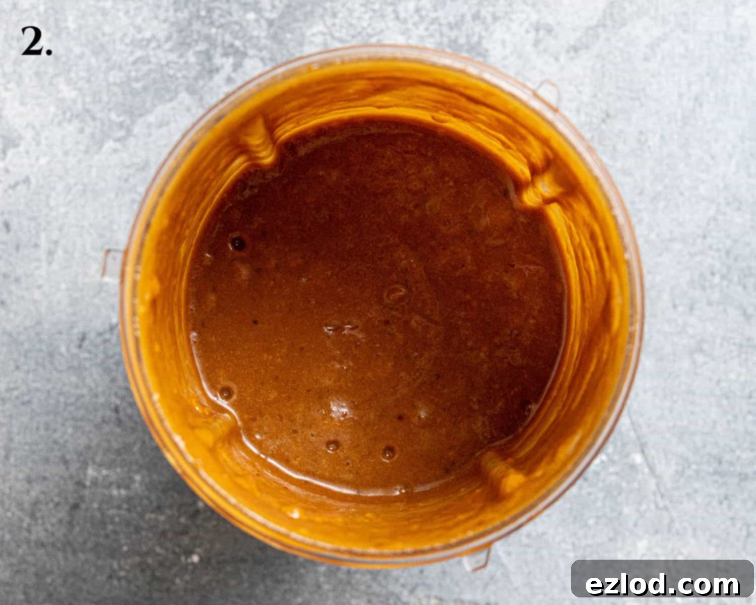 Spiced Pumpkin Sticky Toffee Pudding 6 Step 2: The blended wet ingredients, including dates, pumpkin puree, oil, sugar, and treacle, in a blender jug, ready to be combined with dry ingredients.