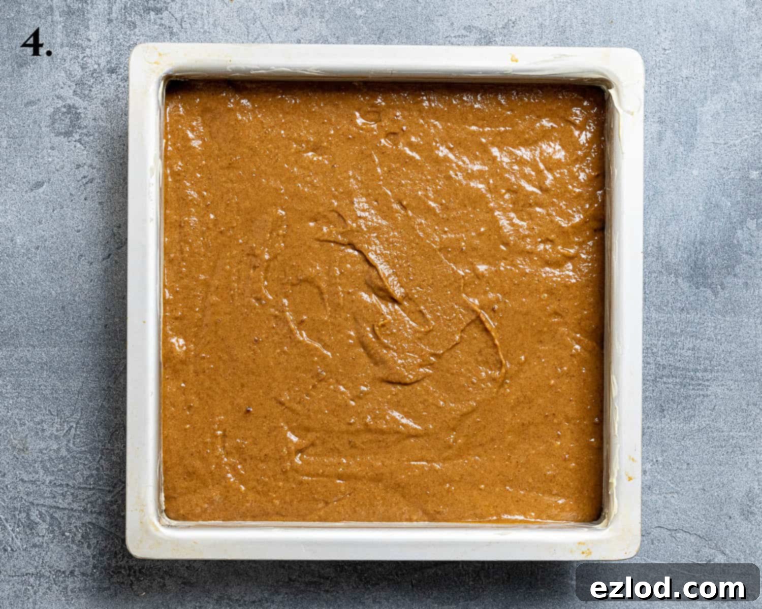Spiced Pumpkin Sticky Toffee Pudding 8 Step 4: The prepared pumpkin sticky toffee pudding batter evenly spread in a greased 20cm square baking tin, ready for baking.