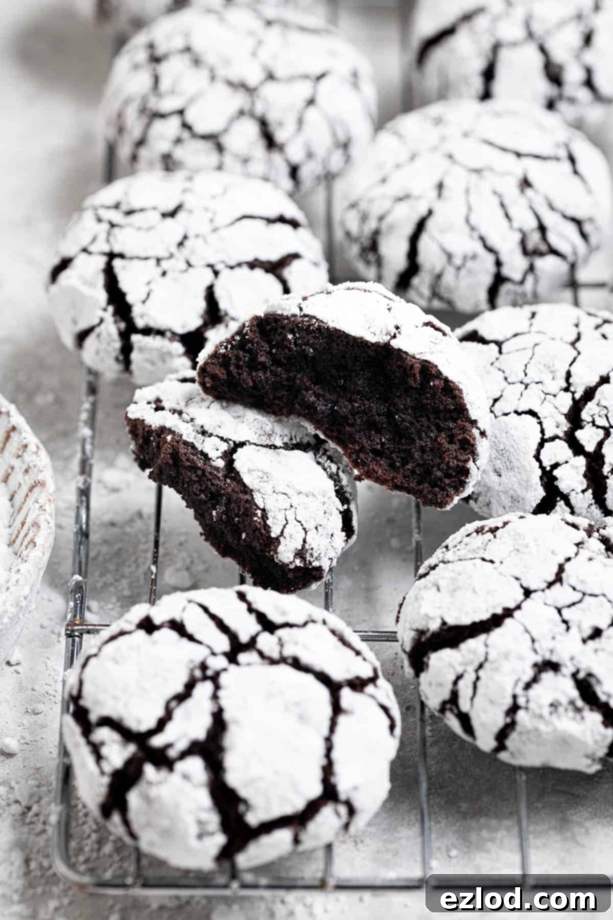 A vegan chocolate crinkle cookie broken in half.