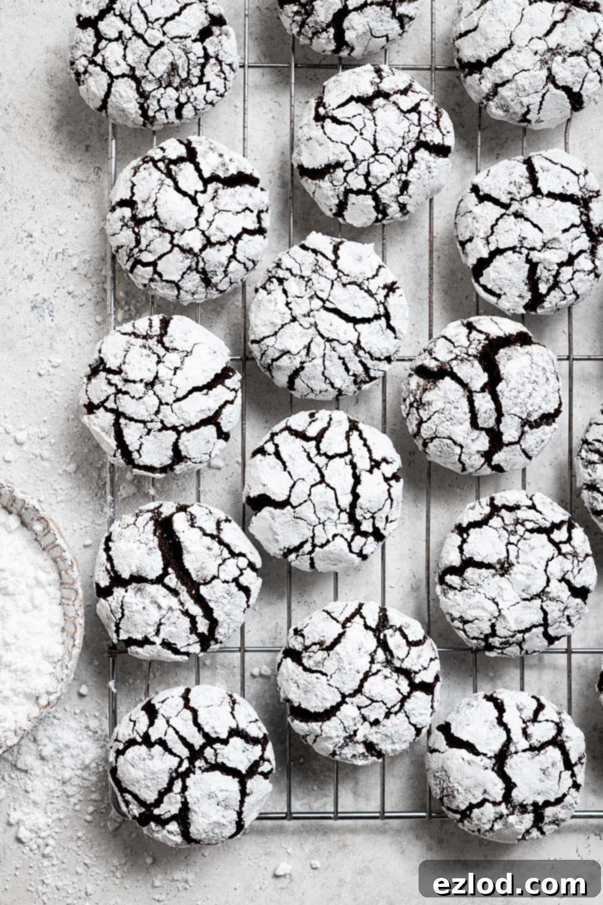 Vegan chocolate crinkle cookies on a wire cooling rack.