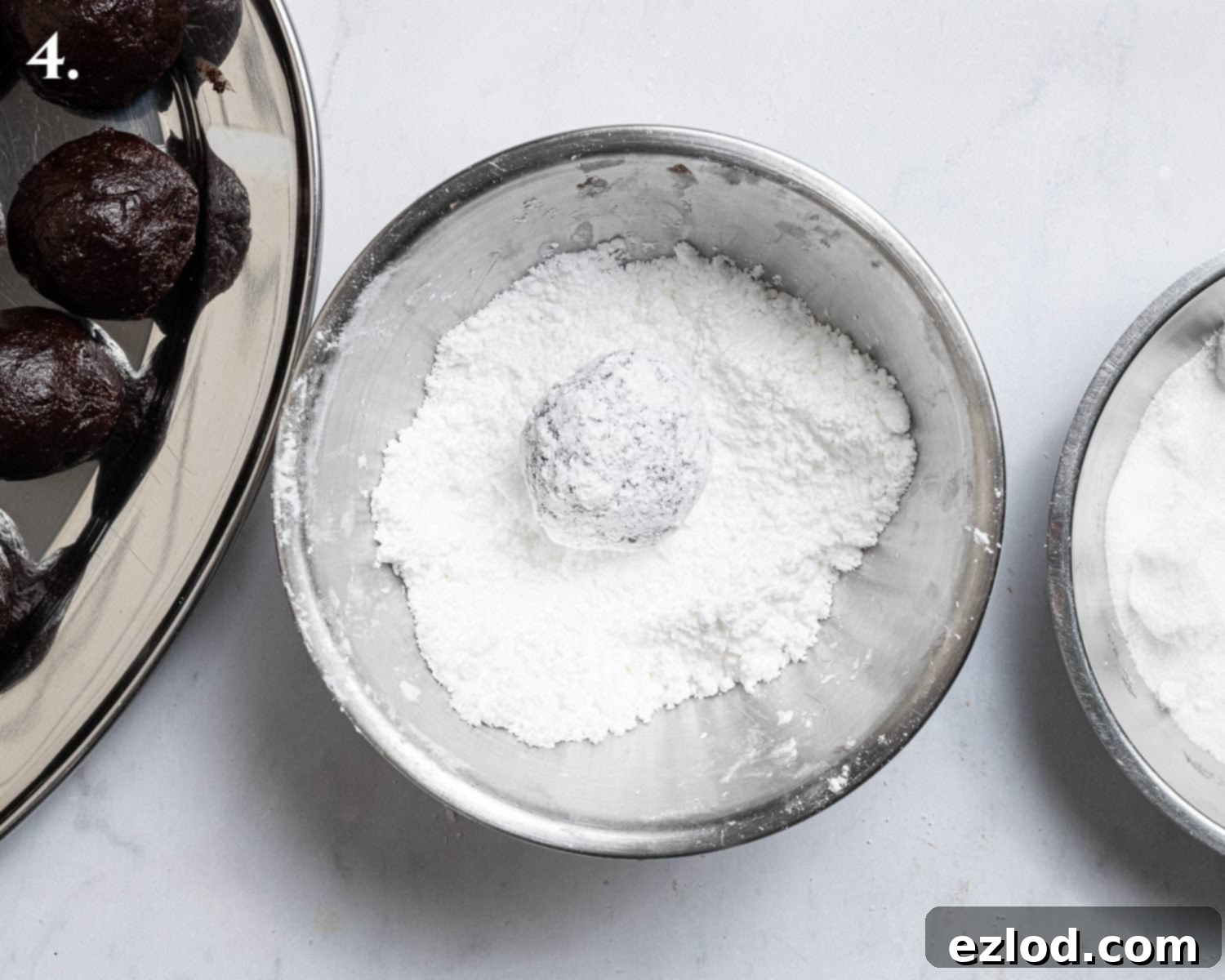 Step 4, coating the dough balls in icing sugar.