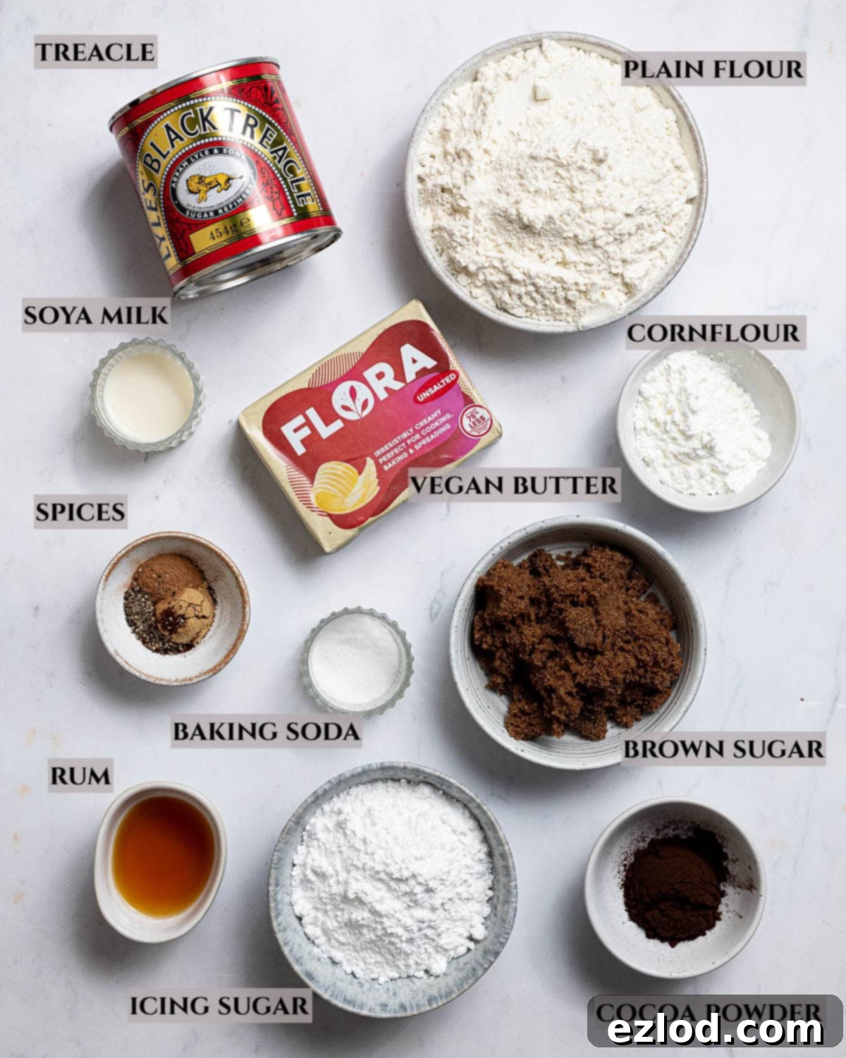 A comprehensive labelled display of the ingredients needed to create these irresistible vegan glazed gingerbread cookies.
