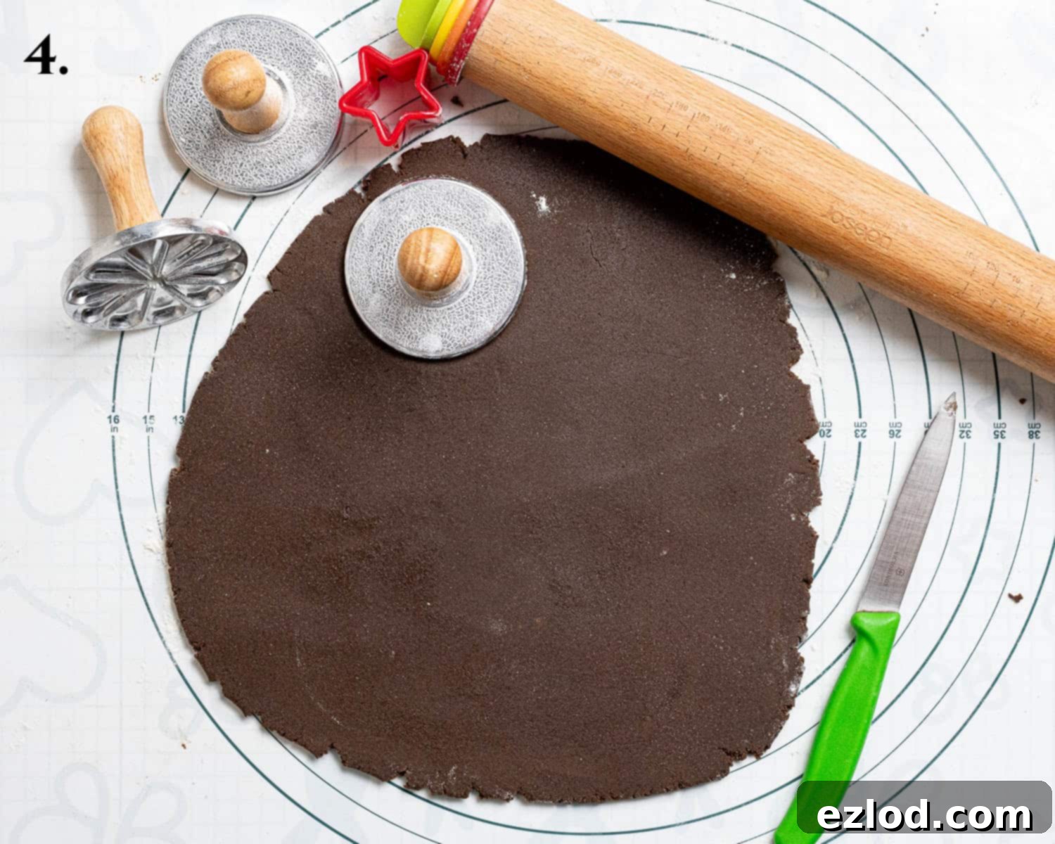 Step 4: Rolling out the chilled dough and stamping it with festive cookie stamps.