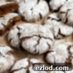 Vegan gingerbread crinkle cookies on a sheet of baking paper.