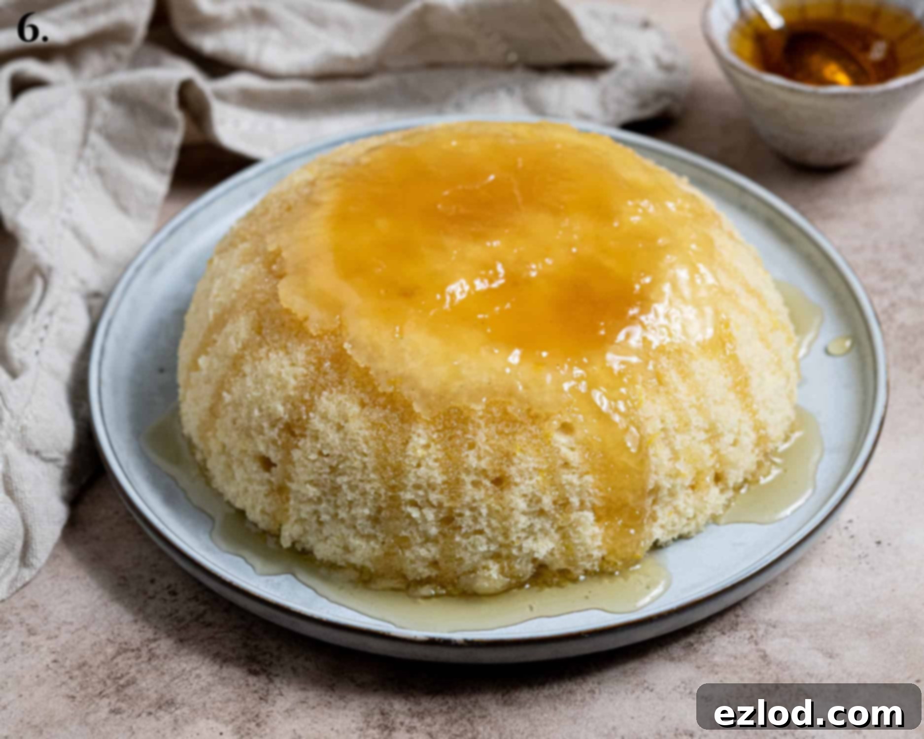 Vegan Microwave Syrup Pudding 10 Step 6, the pudding turned out onto a plate and topped with more golden syrup.