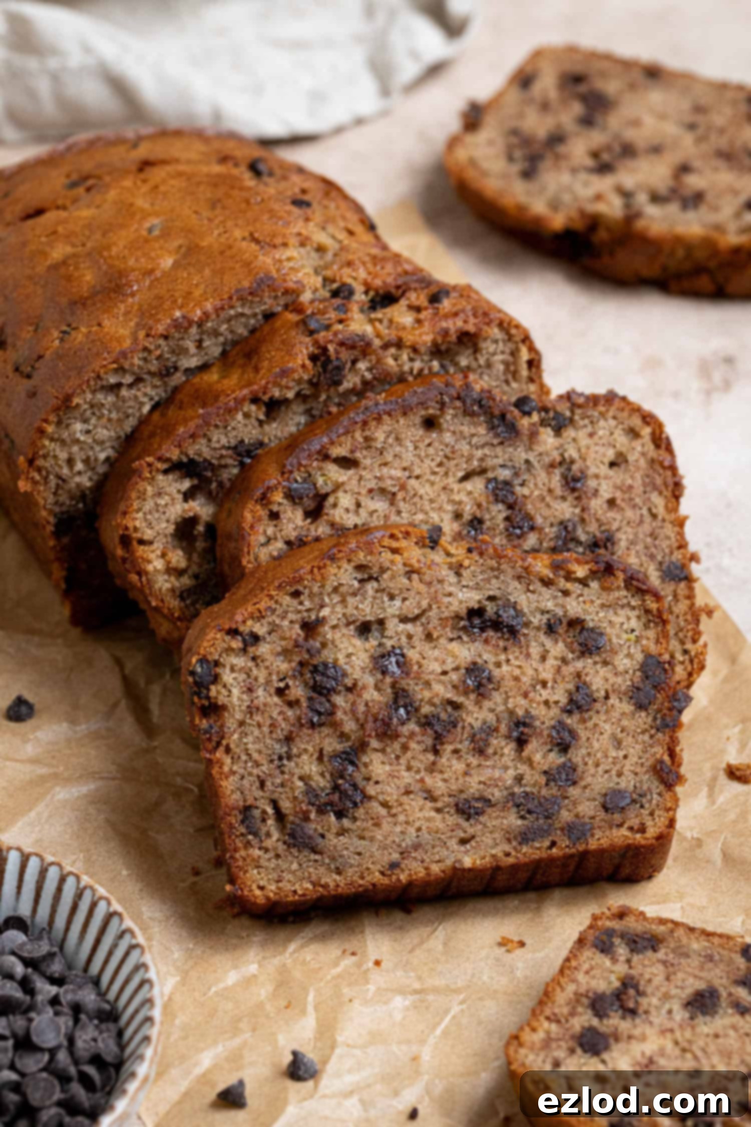 Slices of chocolate chip banana bread on a sheet of baking paper.